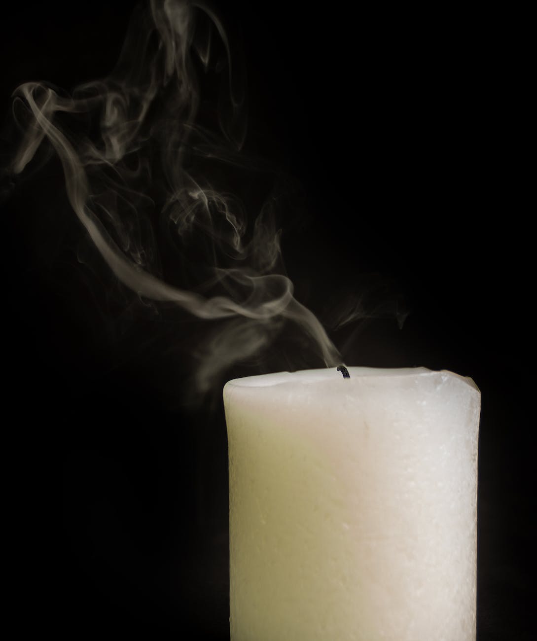 extinguished thick wax candle with smoke