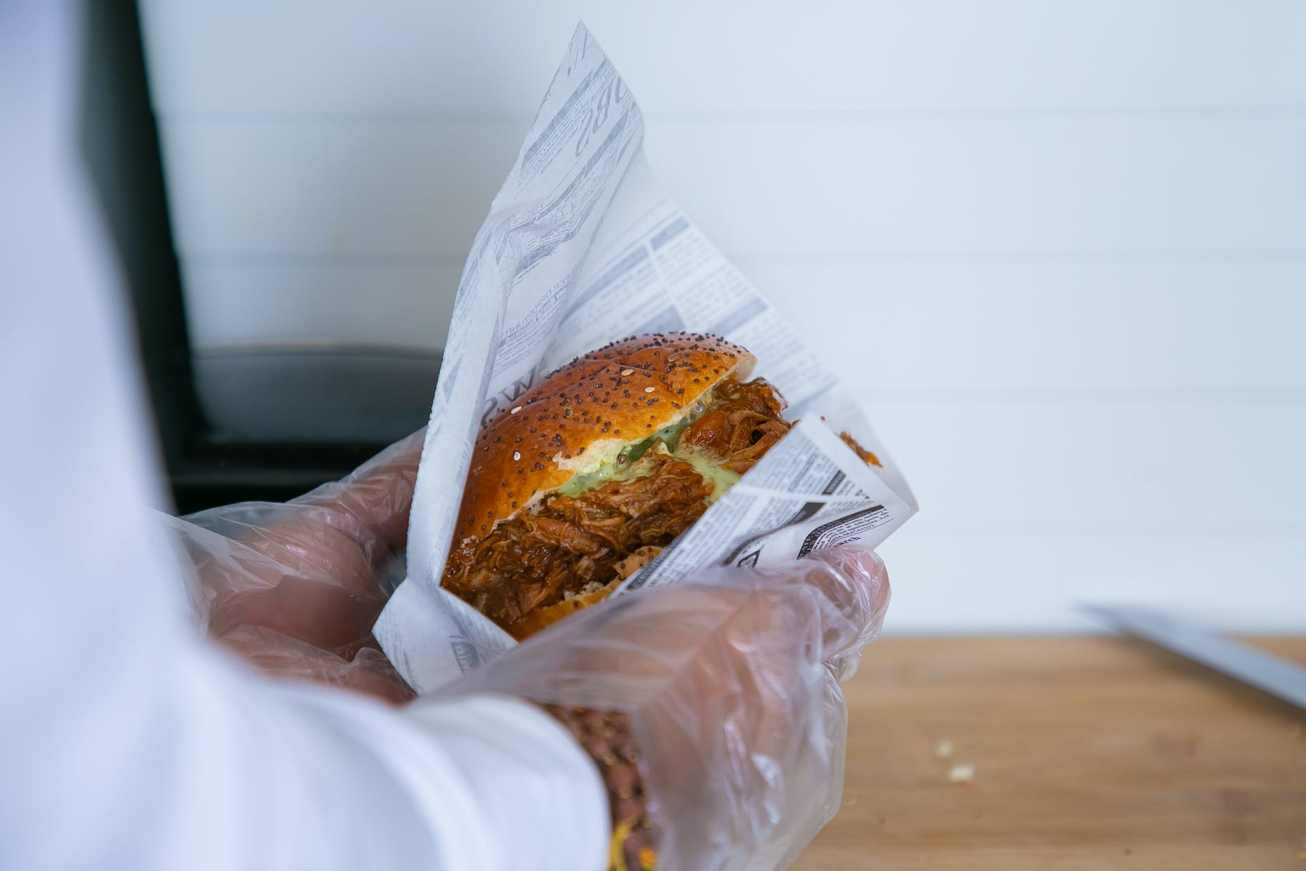 cook wrapping sandwich in paper package