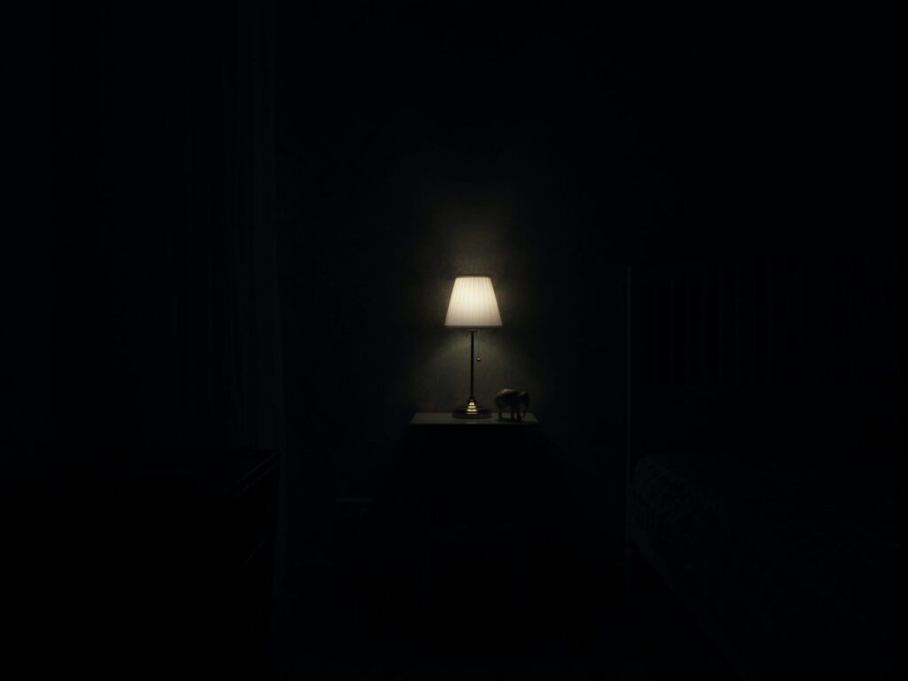 turned on grey table lamp