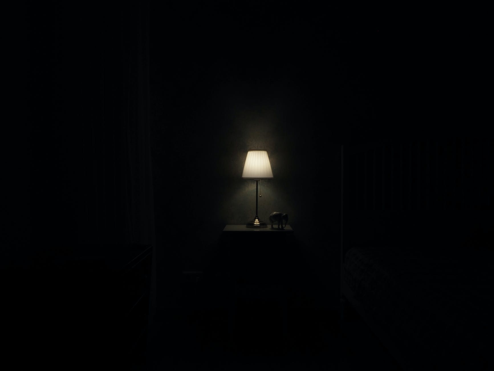 turned on grey table lamp